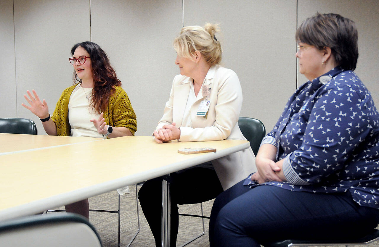 Schelle Fitzpatrick, left, explains her experience in Olympic Medical Center’s nursing residency program as the hospital’s Chief Nursing Officer Vickie Swanson and Director of Education and Organizational Professional Development look on. Since 2017, 132 nurse graduates have gone through the program, which provides clinical experience, mentoring and support. (Keith Thorpe/Peninsula Daily News)