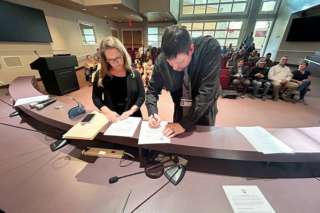 Jon Hamilton, right, is sworn in as a Port Angeles City Council member Tuesday evening in council chambers at Port Angeles City Hall. His first meeting as a council member will be Sept. 16. (City of Port Angeles)