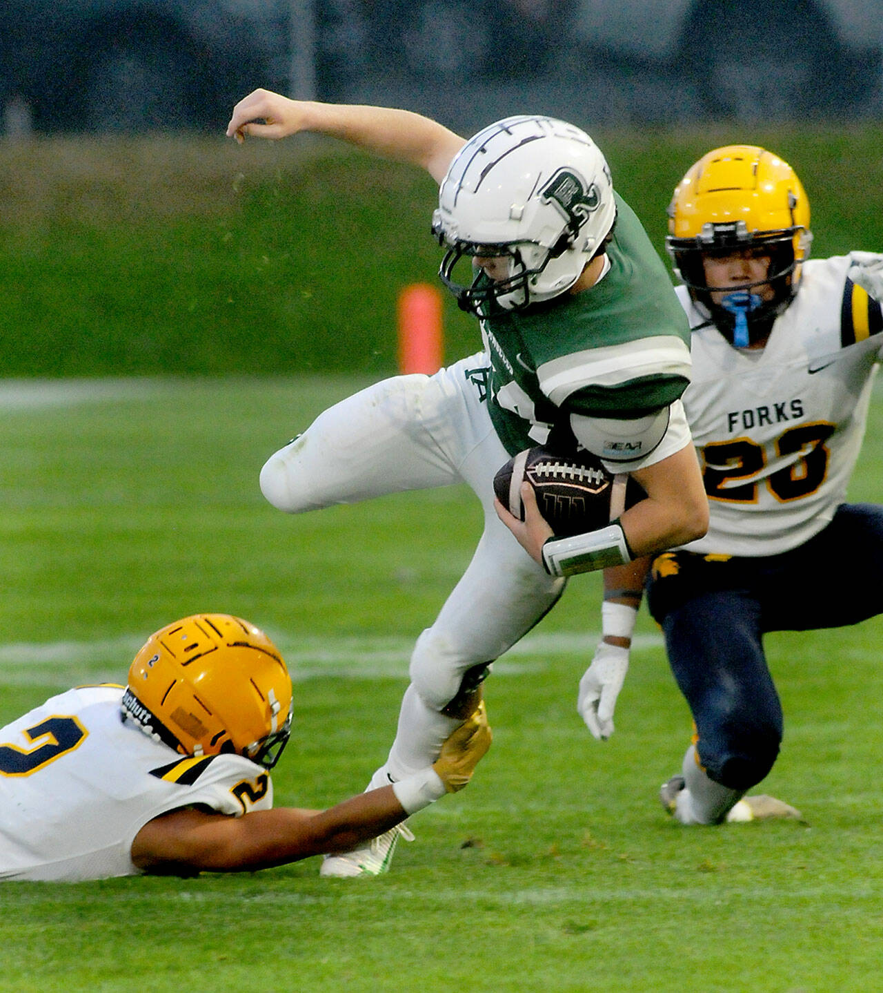 Port Angeles’ Jude Wallace, center, is tripped up by Forks’ Noah Foster, right, after escaping Forks’ Kaden Ward on Friday in Port Angeles. (KEITH THORPE/PENINSULA DAILY NEWS)