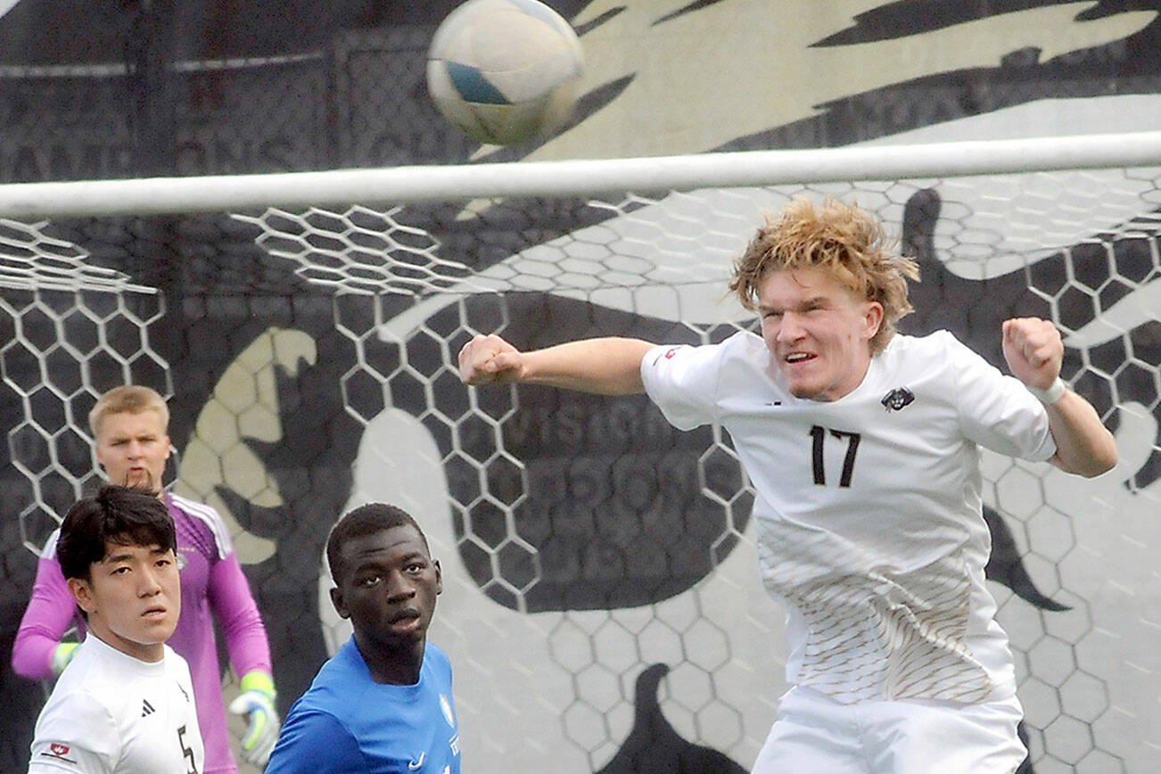 KEITH THORPE/PENINSULA DAILY NEWS
Peninsula's Max Pieper, left, returns a header as teammate Rei Sato, goalkeeper Max Woithe and Edmonds' Omar Kongira keep watch on Saturday afternoon in Port Angeles.