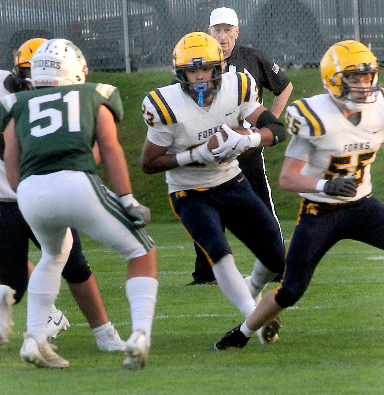 Forks tight end Kaden Ward, center, scrambles for a way past Port Angeles’ Hunter Flores as teammate Conner Roberts, right, sets up a block on Friday evening in Port Angeles. (Keith Thorpe/Peninsula Daily News)