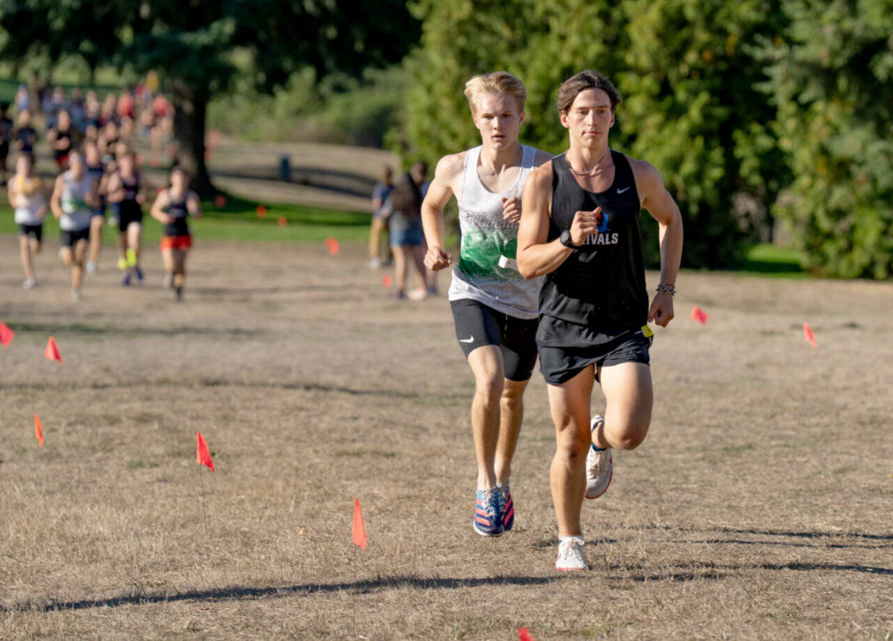 East Jefferson’s Joshua Yearian leads Klahowya’s Carson Wintch in a Nisqually League meet held at Camas Prairie Park on Tuesday. Yearian won the boys’ race. (Steve Mullensky/for Peninsula Daily News)