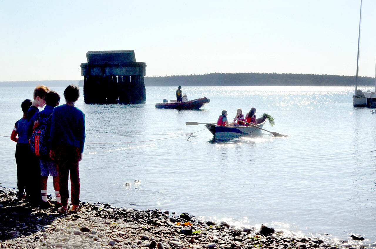 A group of fifth-graders from The Evergreen School in Shoreline launches a boat they built as a part of a week-long Northwest Maritime program. (Elijah Sussman /Peninsula Daily News)