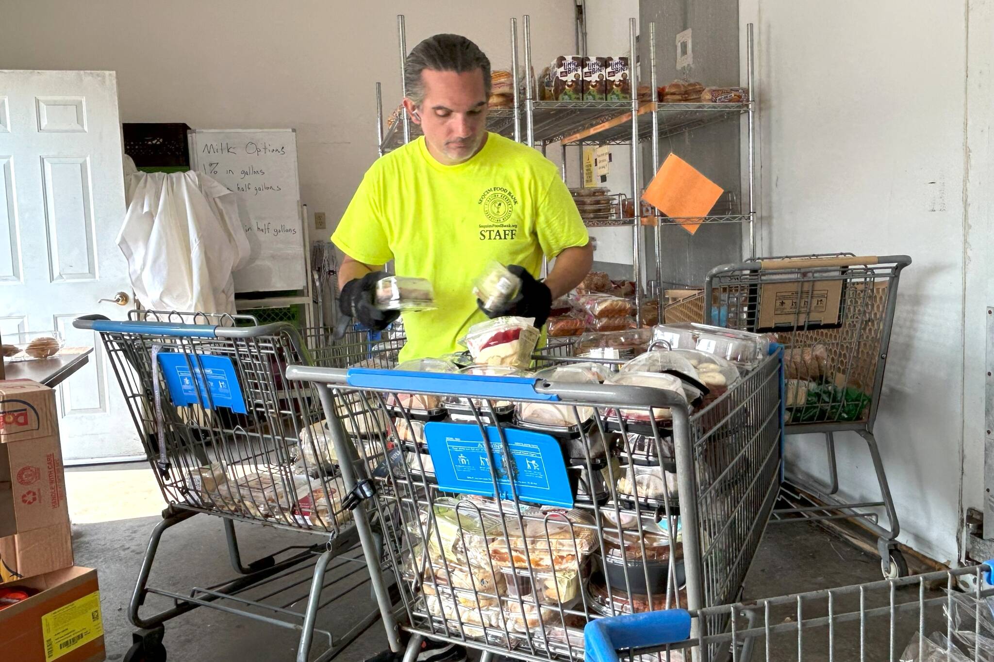 Mark Gebbia, distribution coordinator with the Sequim Food Bank, organizes food for the next distribution day. Staff report that the food bank has budgeted about $600,000 for food this year, and it already has used reserves to match demand. (Matthew Nash/Olympic Peninsula News Group)