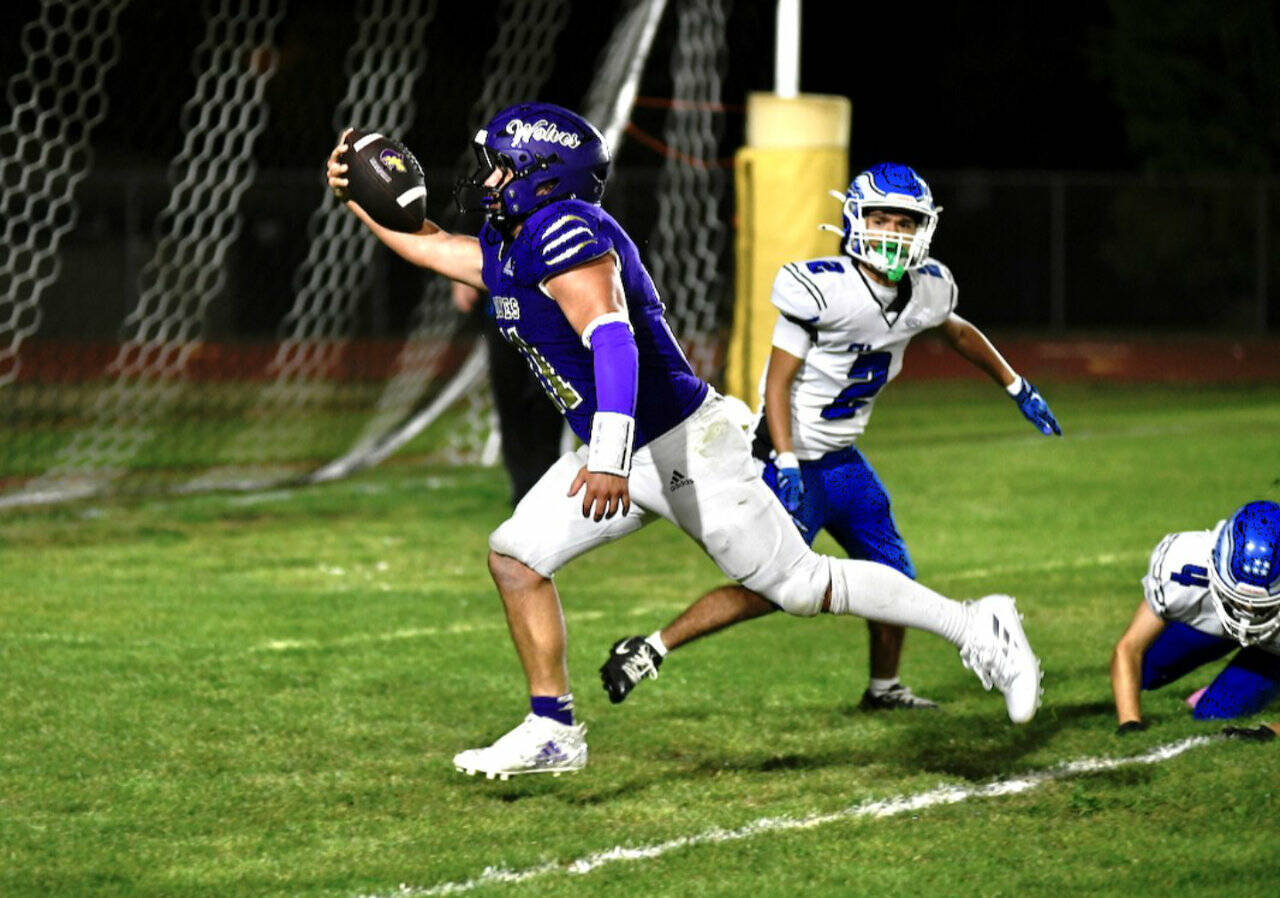 Sequim running back Liam Wiker celebrates after scoring on a 14-yard run against Elma on Friday. Sequim won 49-30. (Jacque Star/Olympic Peninsula News Group)