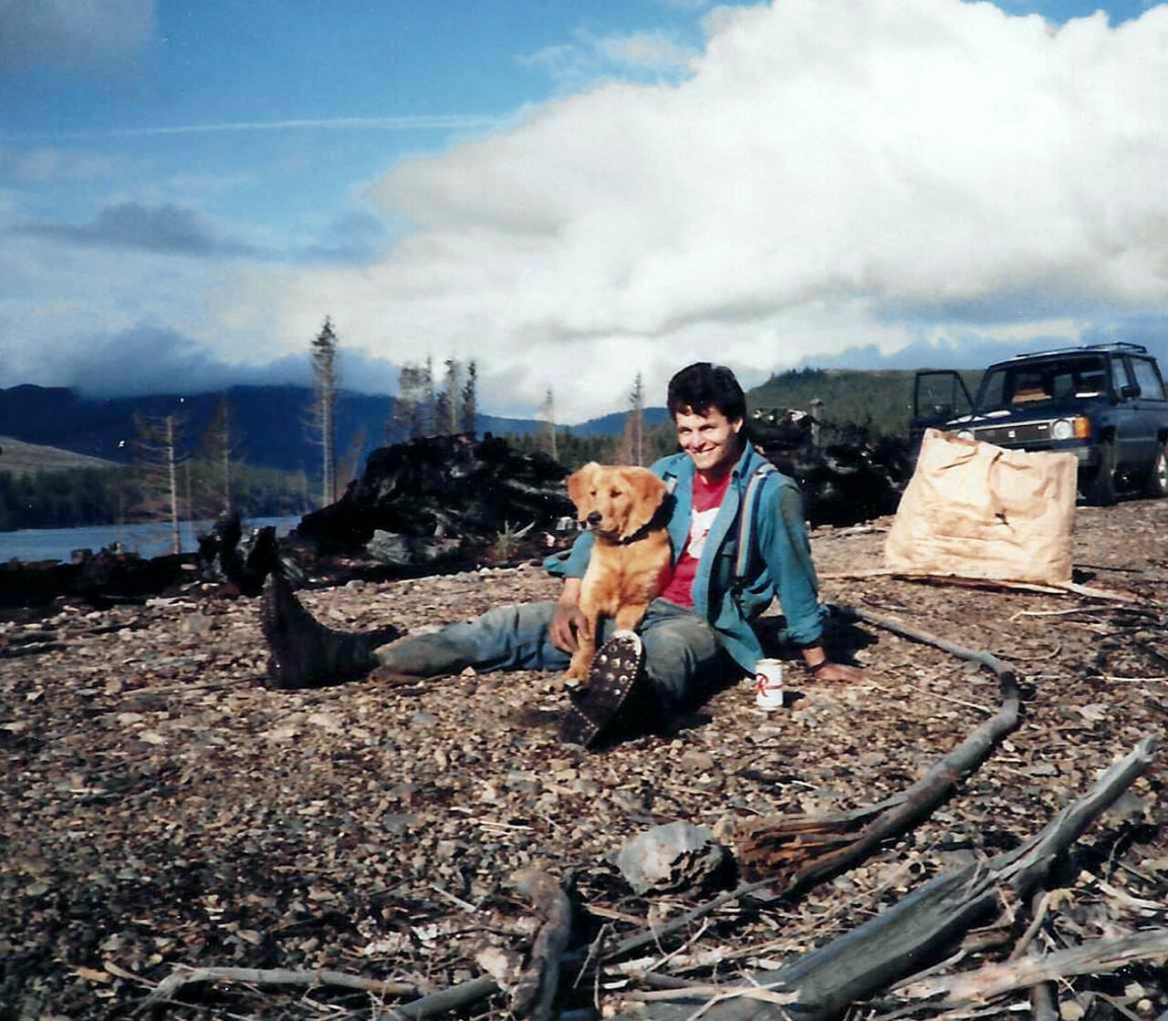 Tom Swanson and his golden retriever, Tyler, during a Society of American Foresters replanting project at Lake Pleasant, five months after a 1985 fire that burned 550 acres on the West End and shut down U.S. Highway 101. (Courtesy photo)