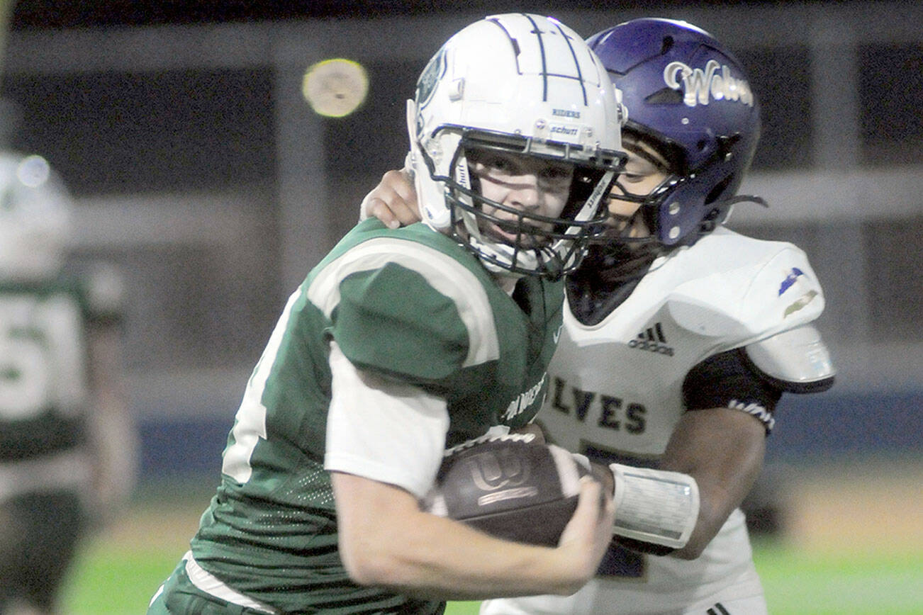 Sequim’s Patrick Elias, left, expresses disbelief after Port Angeles’ Jude Wallace, right, completed a pass reception near the Sequim goal line while teammate Taylor Abold celebrates during Friday night’s game in Port Angeles. (Keith Thorpe/Peninsula Daily News)