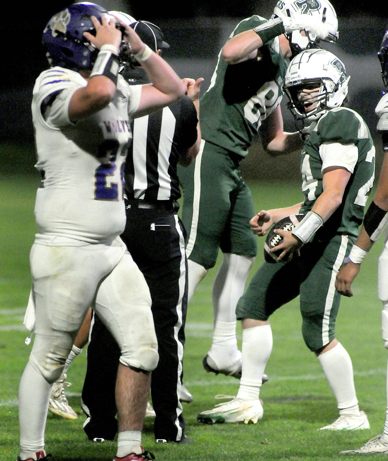 Sequim’s Patrick Elias, left, expresses disbelief after Port Angeles’ Jude Wallace, right, completed a pass reception near the Sequim goal line while teammate Taylor Abold celebrates during Friday night’s game in Port Angeles. (Keith Thorpe/Peninsula Daily News)