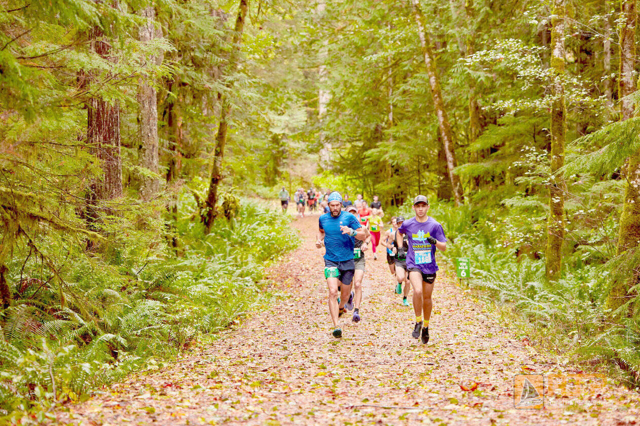 Matt Sagen/Cascadia Films
Competitors in the first Spruce Railroad Trail 5K/10K in 2024 run down a leaf-covered path along Lake Crescent.