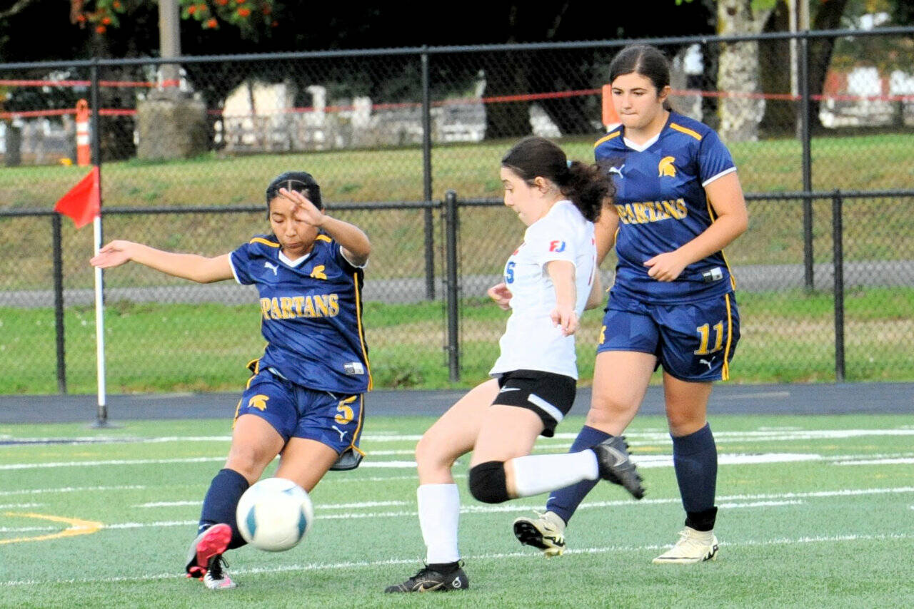 Forks’ Kim Camacho controls the ball in Forks while teammate Kendyl Woody is on the play against East Jefferson’s Paula Ibarra. Forks won the game against an East Jefferson JV squad 7-0. (Lonnie Archibald/for Peninsula Daily News)