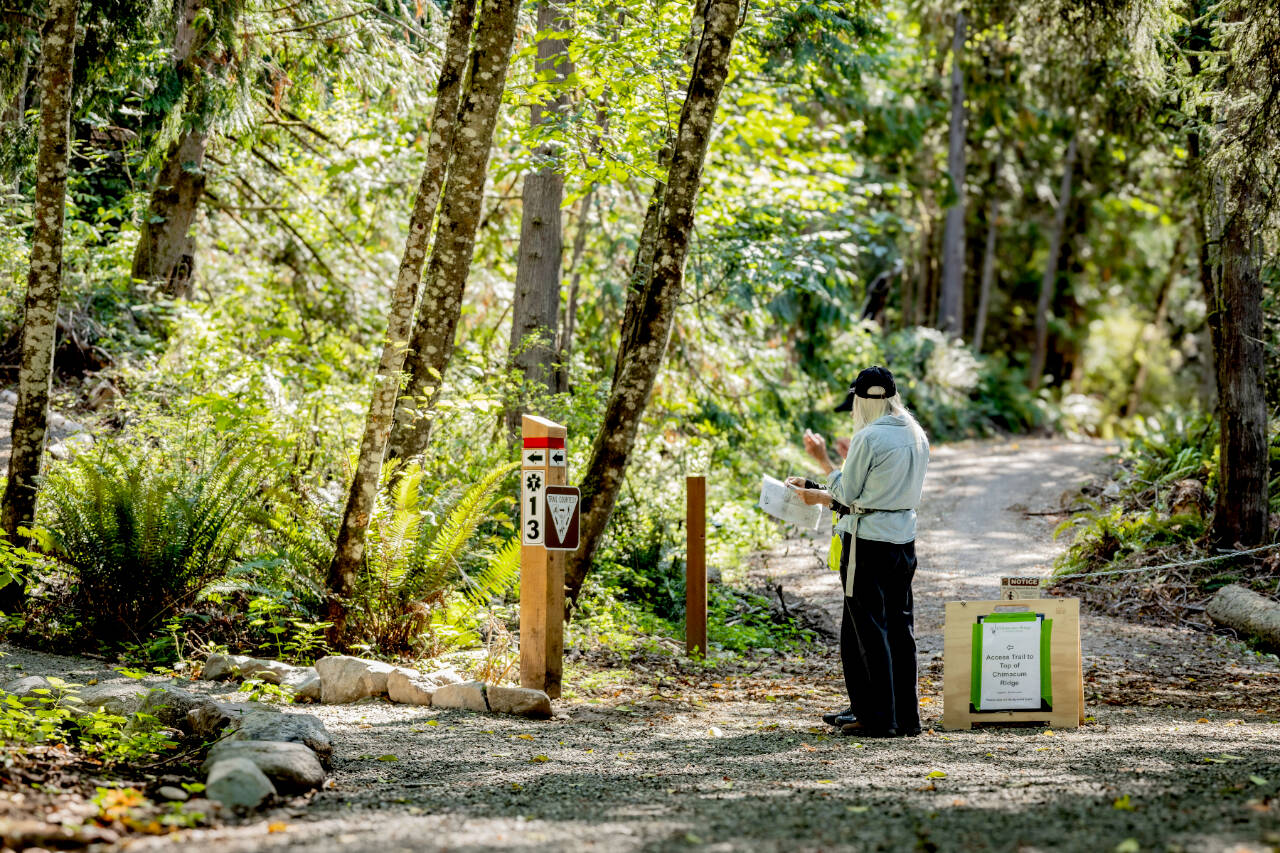 Over the past year, Jefferson Land Trust staff and volunteers have worked hard to complete trails and install signs and other infrastructure to help visitors access and enjoy Chimacum Ridge Community Forest. Here, a guest enjoys the forest during the grand opening celebration event. (Sara Kozak)