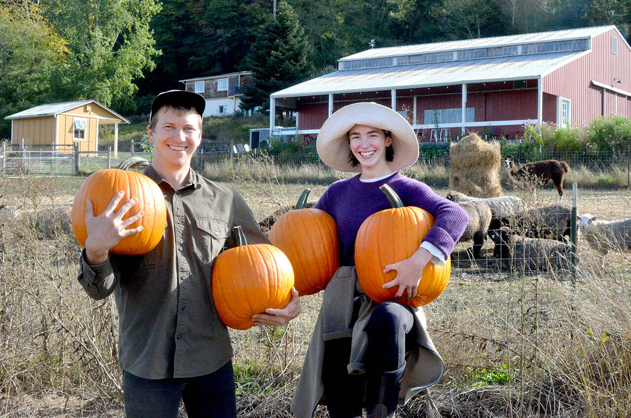 White Lotus Farm’s Niall Motson, left, with Jules Spruill-Smith of Space Twins Provisions. (Elijah Sussman/Peninsula Daily News)