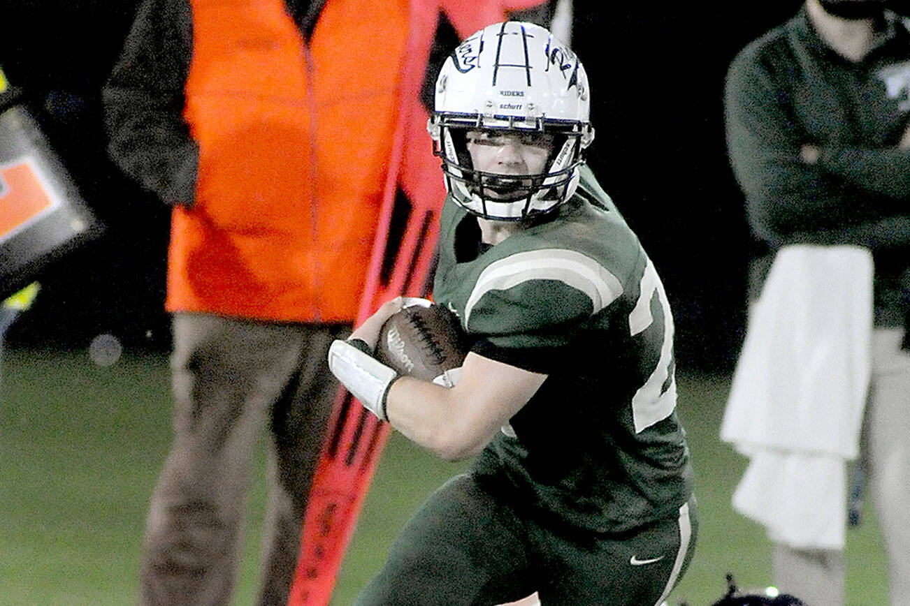 KEITH THORPE/PENINSULA DAILY NEWS
Port Angeles' Jude Wallace breaks away from a would-be tackle by North Kitsap's Tyler Prouse on Friday night at Port Angeles Civic Field.
