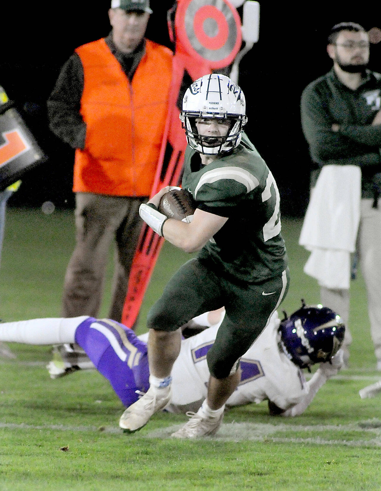 KEITH THORPE/PENINSULA DAILY NEWS Port Angeles’ Jude Wallace breaks away from a would-be tackle by North Kitsap’s Tyler Prouse on Friday night at Port Angeles Civic Field.