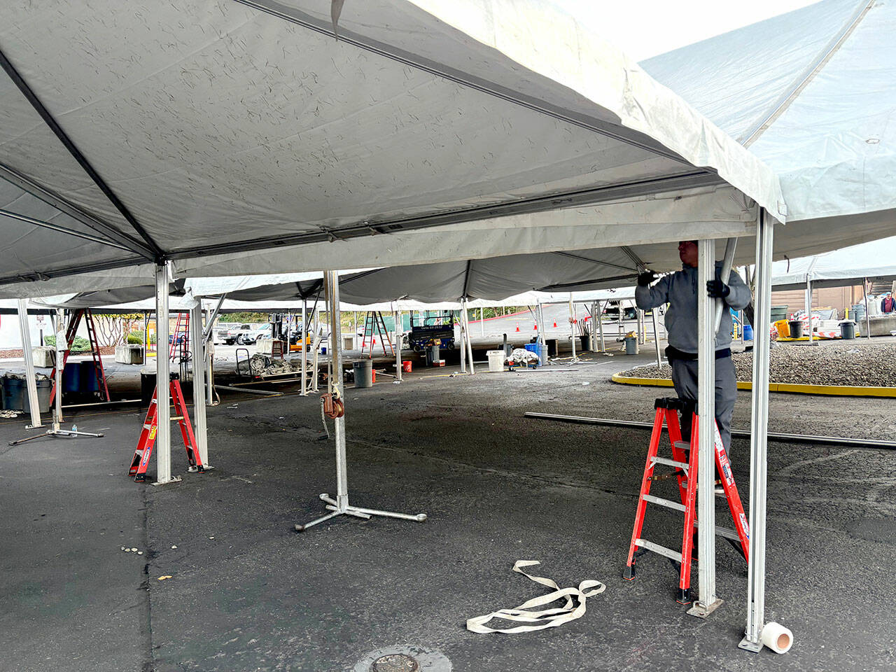 Workers set up the main tent for the Dungeness Crab Festival in downtown Port Angeles on Wednesday evening. (Kelley Lane/Peninsula Daily News)