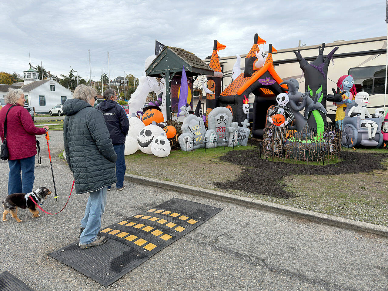 A group of friends stop to look at a Halloween display put up by the camp host at the RV park at Point Hudson Marina. (Steve Mullensky/for Peninsula Daily News)