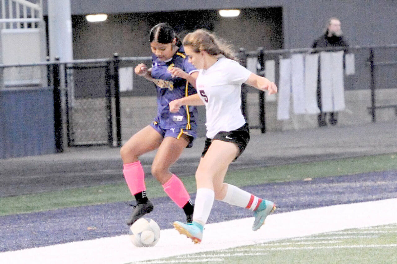Forks’ Vivi Luna competes with Ocosta’s Penny Park for ball control Monday at Spartan Staidum. The game ended in a 1-1 tie. (Lonnie Archibald/for Peninsula Daily News)