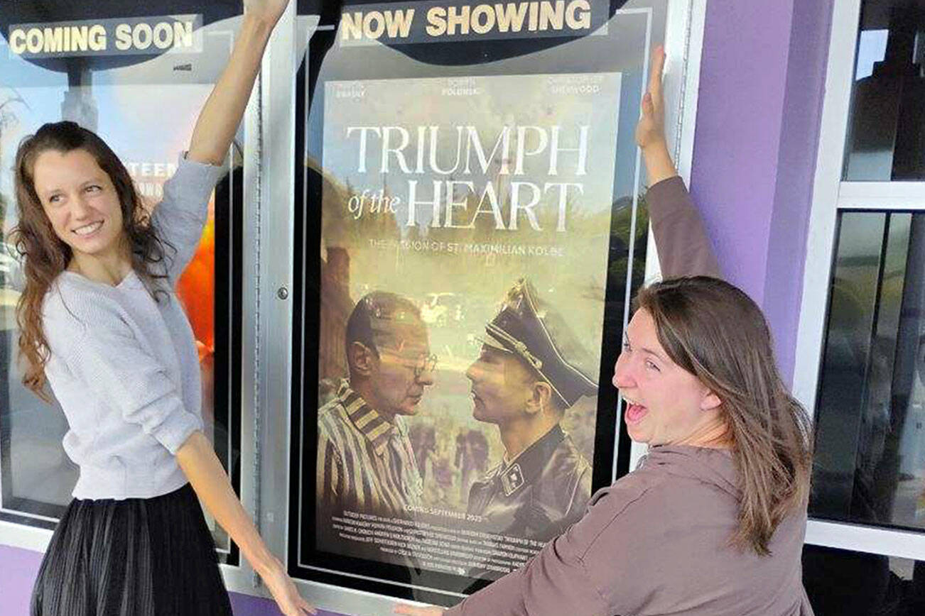 "Triumph of the Heart" producer Cecilia Stevenson, left, and her longtime friend, Amy Catterson, show off the movie poster Oct. 19 at Deer Park Cinemas.