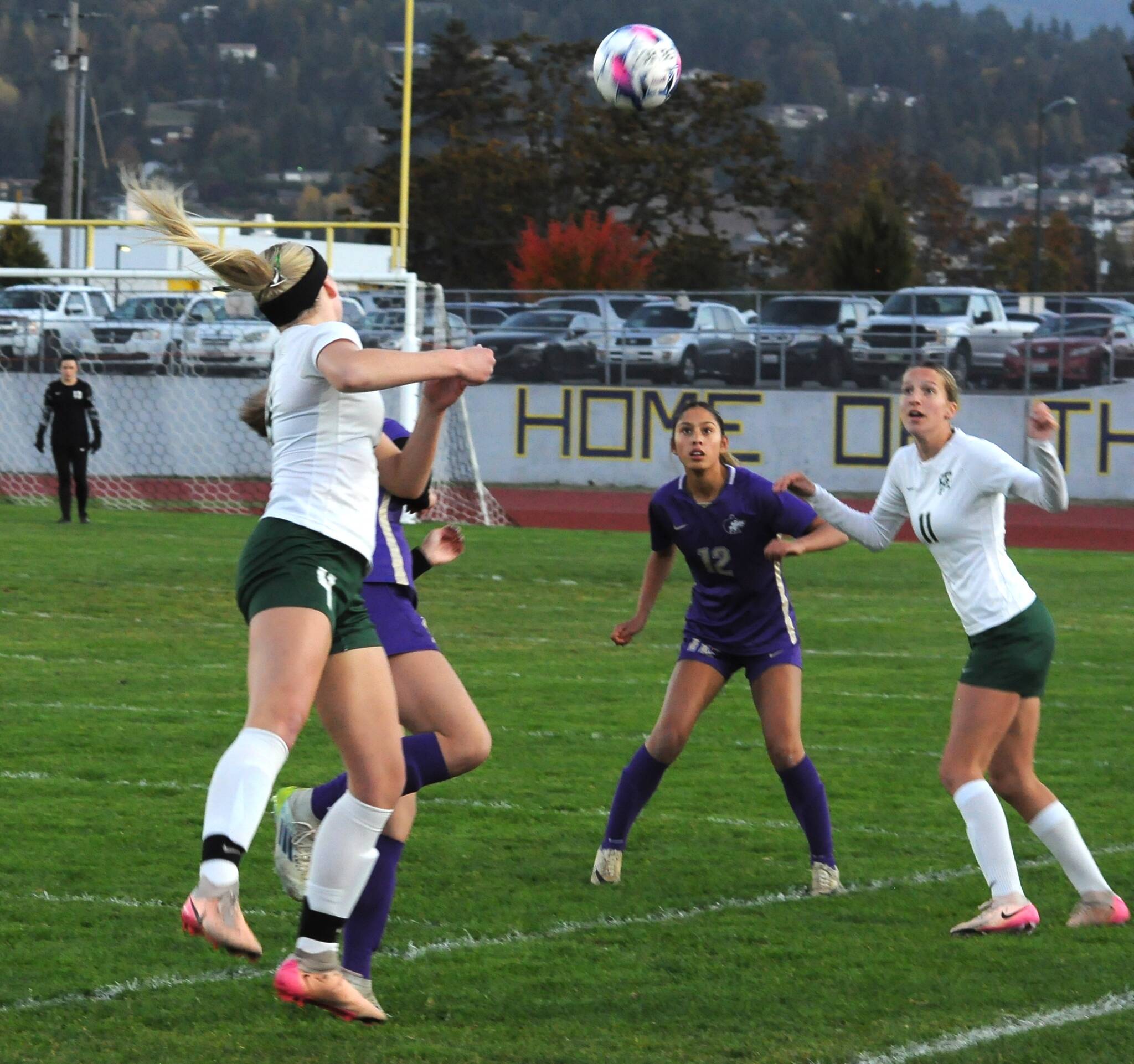 Matthew Nash/Olympic Peninsula News Group 
Port Angeles’ Mariah Traband, left, heads a ball past Sequim’s Harper Moore and toward teammate Morgan Politika, right, and Sequim’s Brooklynn Schmidt during a game earlier this month.