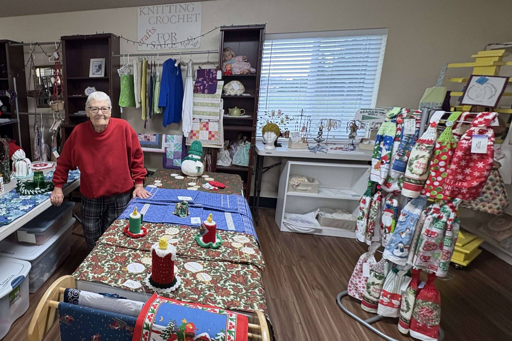 Judy Lange stands in the craft store at the Shipley Center amid items made by the fiber arts group she leads. Items from the store will be sold at the Shipley Center Holiday Bazaar scheduled for Friday and Saturday. (Reba Renner)
