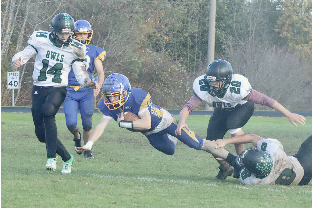 Crescent's Liam Sprague stretches for more yardage against Mary M. Knight on homecoming day at Crescent High School. The Loggers won to finish the season 9-0. (Dave Logan/for Peninsula Daily News)
