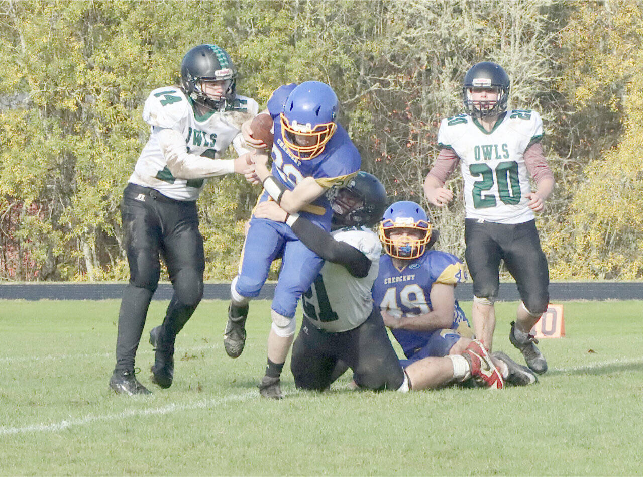 Crescent’s Jackson Girard (20) fights to get to the goal line pylon in first half action against Mary M. Knight in Joyce on Saturday. Helping to block is Connor Avrett (49). (Dave Logan/for Peninsula Daily News)