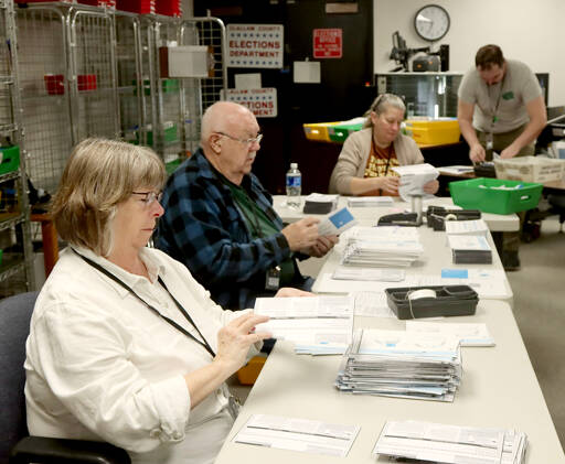 From left to right, Neva Miller, Ray Farrell, Shellie Andrews and Ryan O’Hara process election ballots on Tuesday morning at the Clallam County Courthouse in Port Angeles. Initial results were posted after press time and are available at www.peninsuladailynews.com. For full coverage, see Thursday’s print and online editions. (Dave Logan/for Peninsula Daily News)