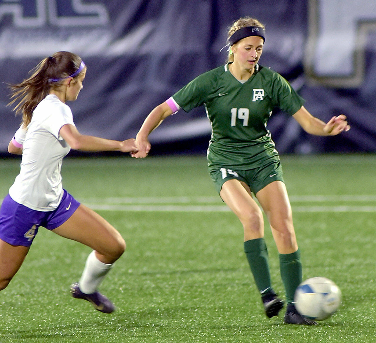 KEITH THORPE/PENINSULA DAILY NEWS 
Port Angeles’ Becca Manson, right, works to keep control as Sequim’s Raimey Brewer approaches in midfield during an October match at Wally Sigmar Field at Peninsula College.