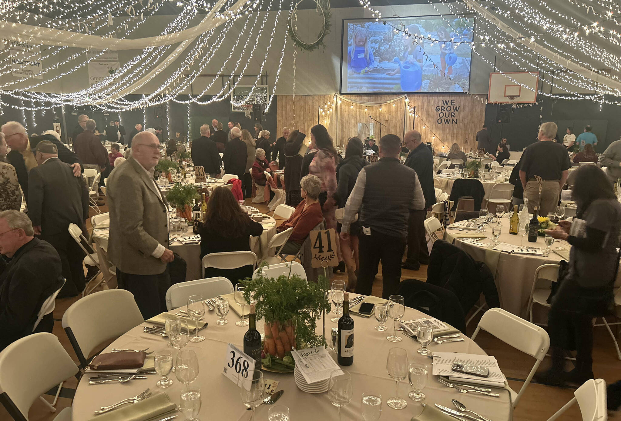 The gym at the Sequim Boys and Girls Club was transformed for the dinner and auction, themed “We Grow Our Own,” with 400 guests seated among 40 tables, each with 10 place settings. (Kathy Cruz/Olympic Peninsula News Group)