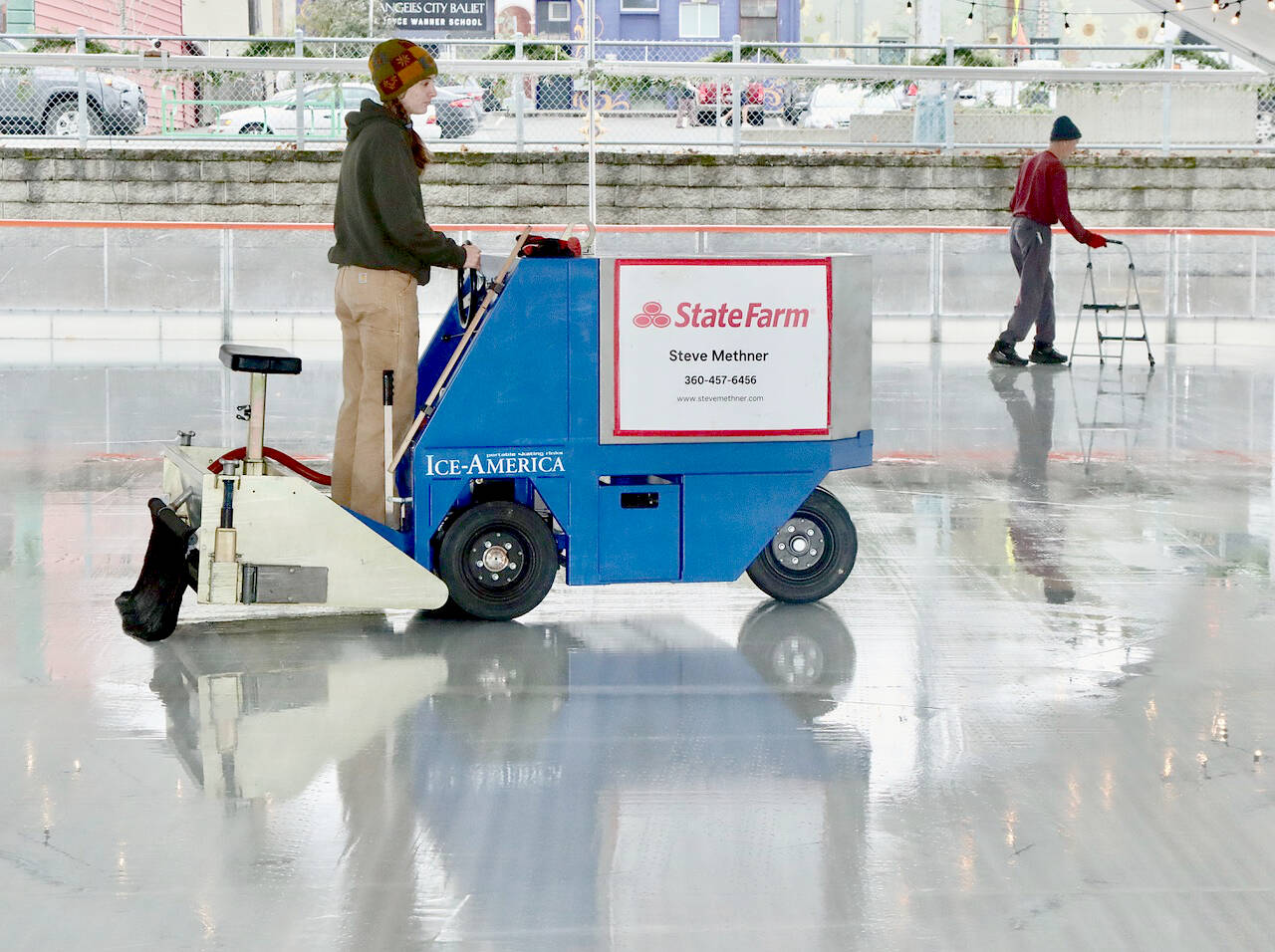 Volunteer Laken Folsom runs the ice resurfacing machine in preparation for opening day on Friday at the Winter Ice Village in Port Angeles. (Dave Logan/For Peninsula Daily News)