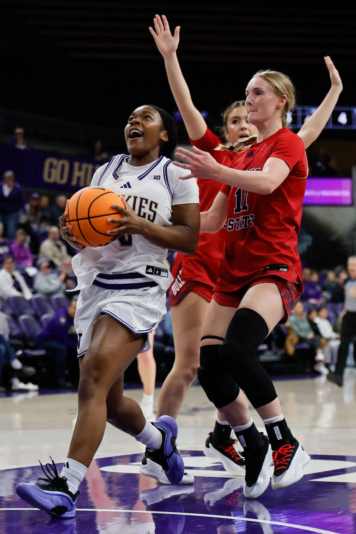 Jennifer Buchanan/The Seattle Times 
Washington guard Sayvia Sellers drives to the hoop while defended by Fresno State’s Ava Marr, center, and Millie Long on Wednesday in Seattle.