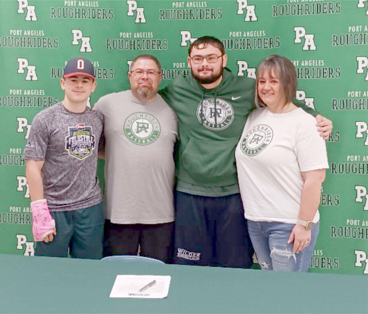 Kody Williams poses with his family after signing a commitment to play baseball for Skagit Valley College in Mount Vernon. From left are brother Kyler Williams, father Josh Williams, Kody and mother Jenny Williams. (Pierre LaBossiere/Peninsula Daily News)