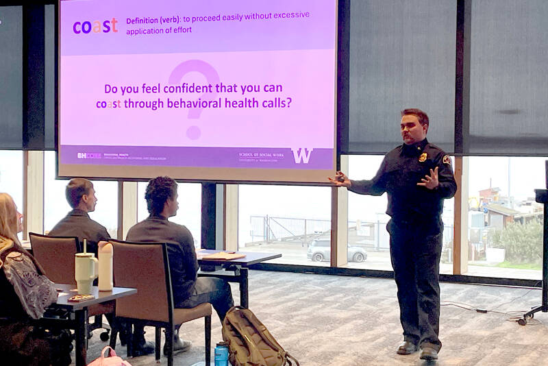 Tyler Gage, Port Angeles Fire Department EMS division chief, leads a training for first responders that equips them with skills for handling mental health and substance abuse calls. Called “COAST,” the program was developed by the Behavioral Health Crisis Outreach Response and Education center operated by the University of Washington School of Social Work. (Paula Hunt/Peninsula Daily News)