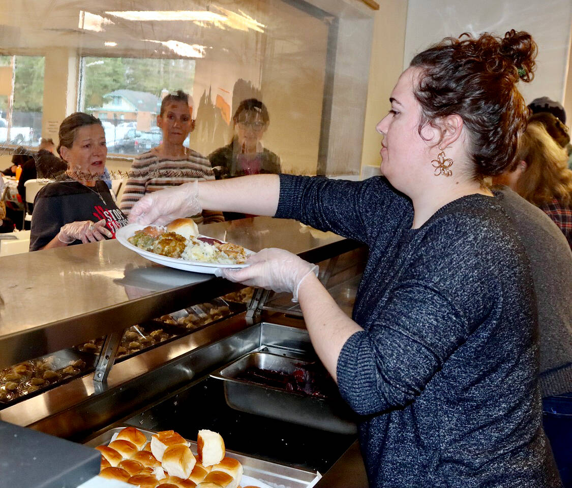 Volunteer Rachel Heath helps serve a full Thanksgiving meal at the Salvation Army Pantry on Wednesday. (Dave Logan/for Peninsula Daily News)