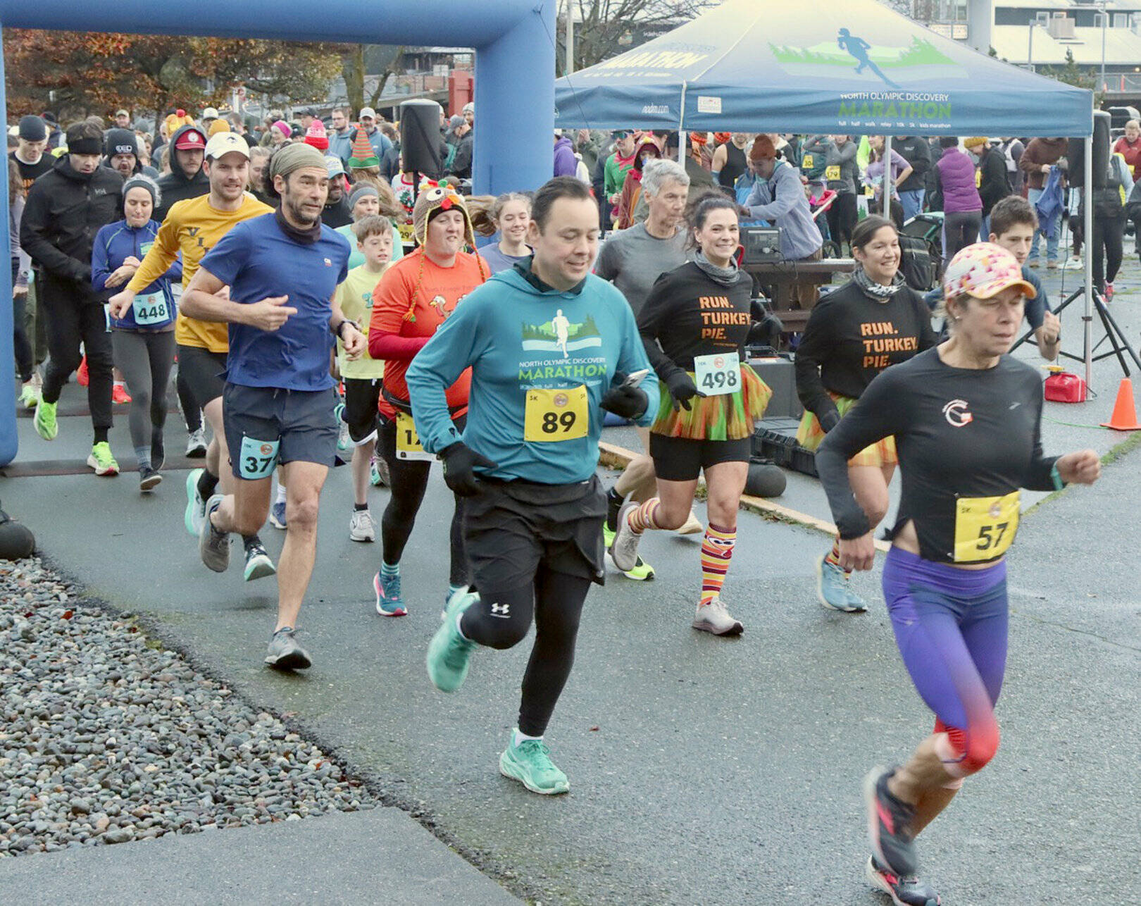 Runners take off at the Port Angeles waterfront in the annual Thanksgiving Day Turkey Trot. The men’s 10K winner Michael Higuera (No. 372, in dark blue), is at the front of the pack. (Dave Logan/for Peninsula Daily News)