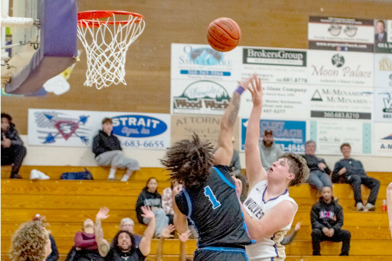 Sequim sophomore Andy Reynolds, at 6-foot-4, here shooting against Washington in Sequim on Saturday, looks to be a big contributor inside for the Wolves basketball team this season. (Emily Matthiessen/for Peninsula Daily News)
