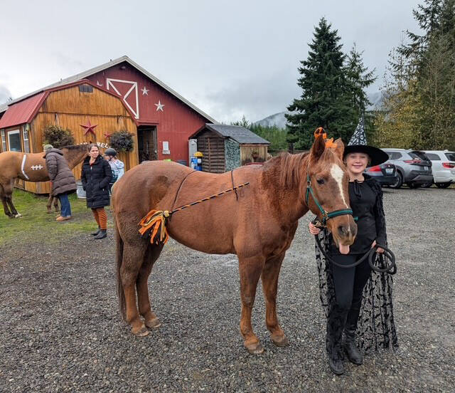 During Living Well Farm’s Halloween Party students, such as Autumn Silva, with Penny, wore costumes and took part in fun events like apple bobbing, obstacle course and pumpkin carving.
