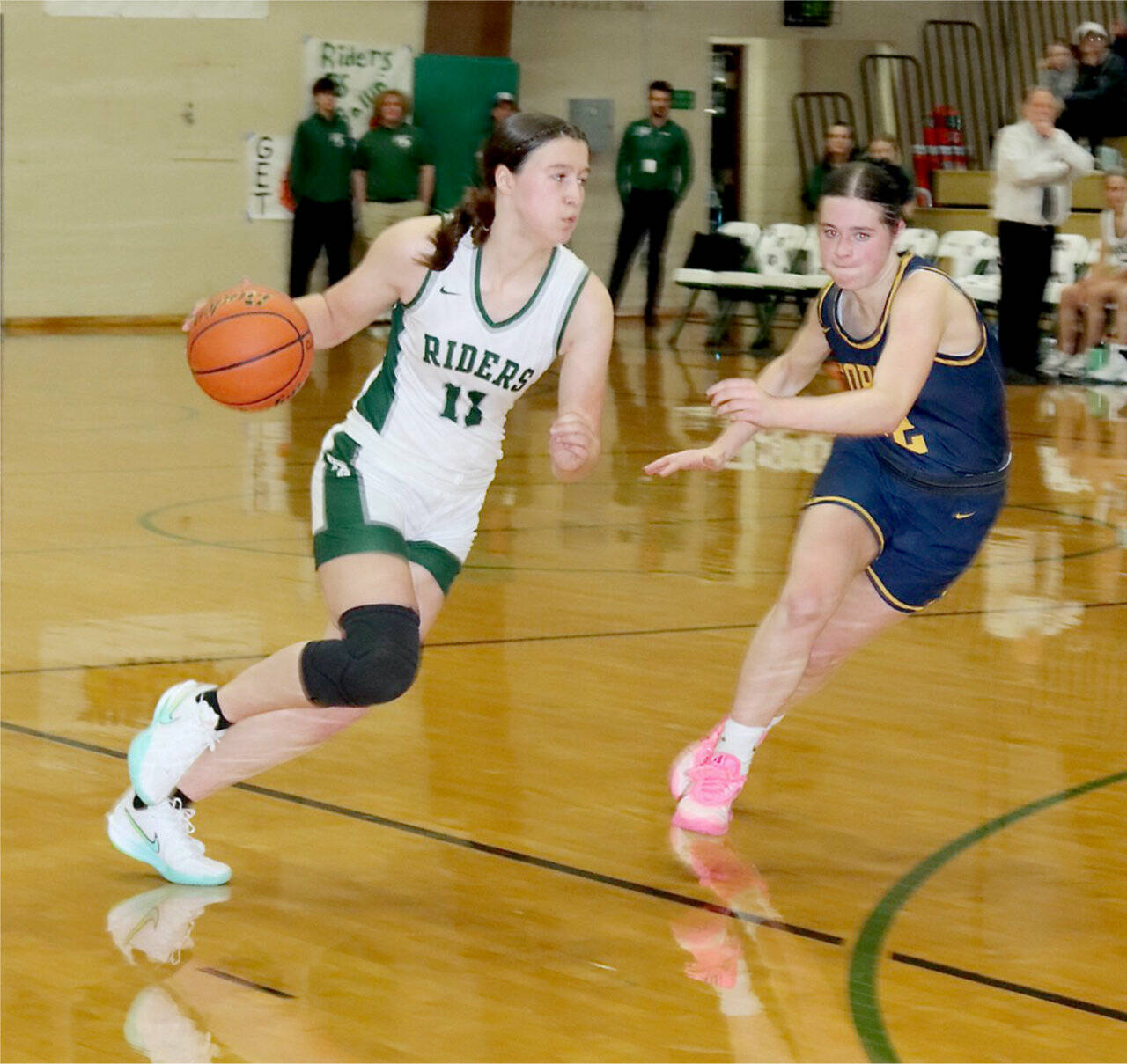 Port Angeles’ Lindsay Smith drives against Forks’ Chloe Gaydeski on Tuesday in Port Angeles. Forks won 38-35. (Dave Logan/for Peninsula Daily News)