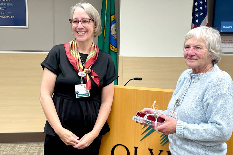Olympic Medical Center Board President Ann Henninger, left, recognizes commissioner Jean Hordyk on Wednesday as she steps down after 30 years on the board. Hordyk, who was first elected in 1995, was honored during the meeting. (Paula Hunt/Peninsula Daily News)