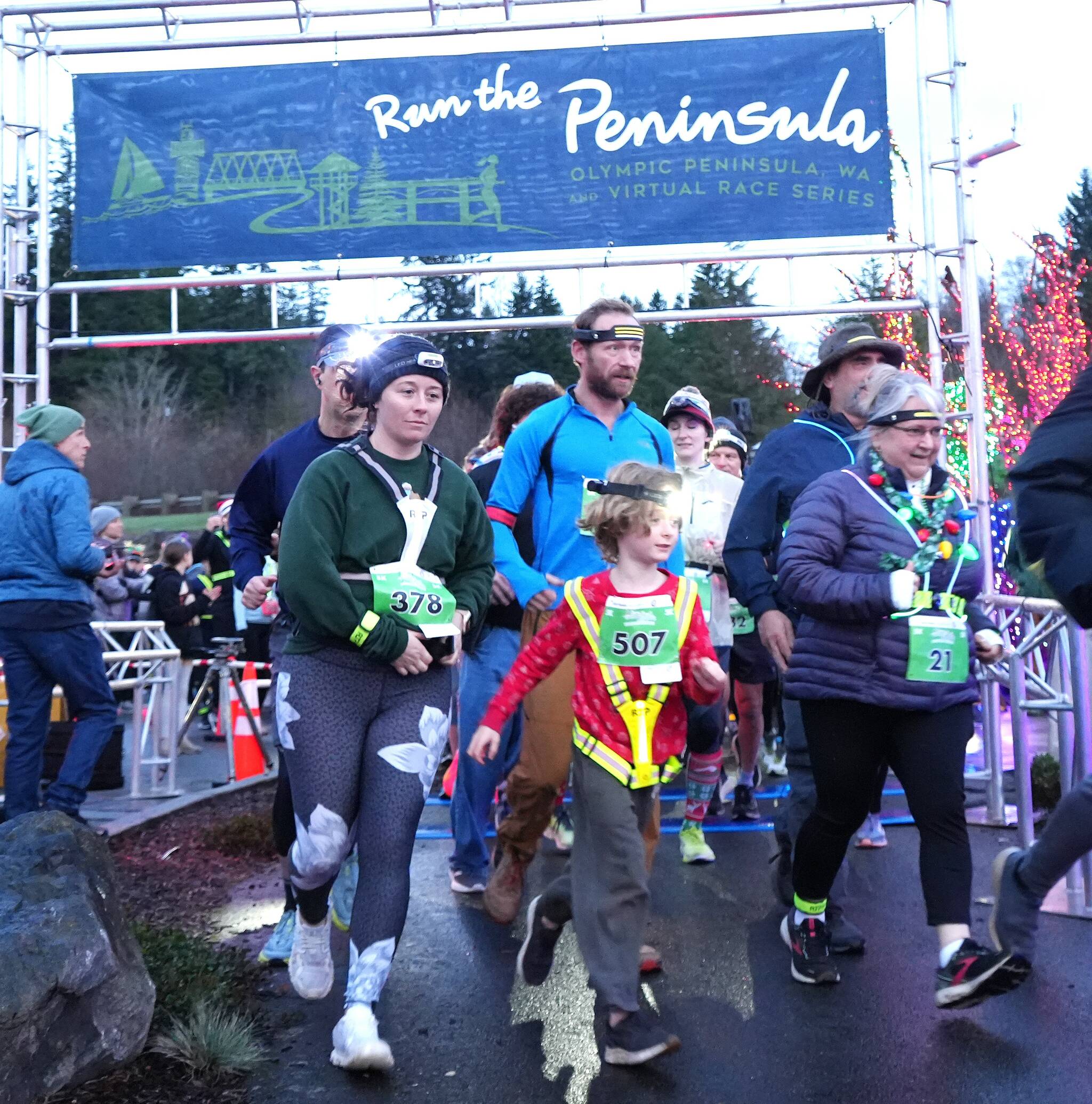 Aaliyah Clark of Poulsbo (378) and Monica Castleberry of Lacey (21) lead a young runner at the start of the Jamestown S'Klallam Glow Run in Blyn late Saturday afternoon. The race had a record-breaking 900 participants this year. (Michael Dashiell/Jamestown S'Klallam Tribe)