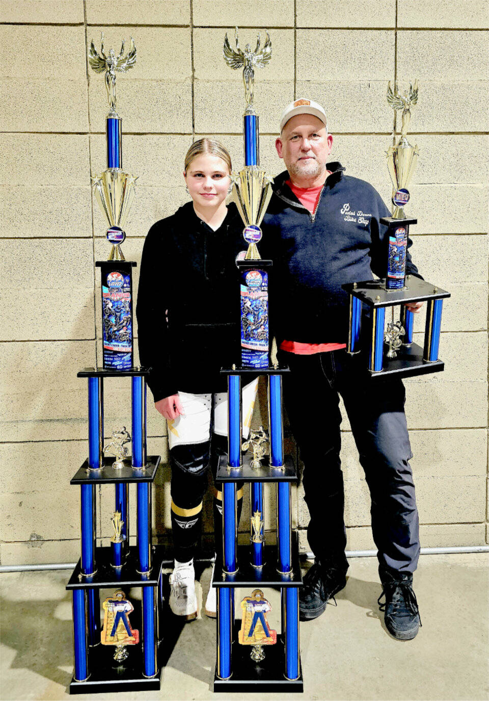 Kylin Weitz, 12, of Port Angeles, finished second in the 12 girls expert class and 12 girls cruiser class at the BMX USA Grant Nationals in Tulsa, Okla., last week, just seven weeks after fracturing her ankle at the world championships in Copenhagen. At right is Sean Coleman, Lincoln Park BMX operator, who finished seventh in the 51-55 novice class. (Britney Rowland)