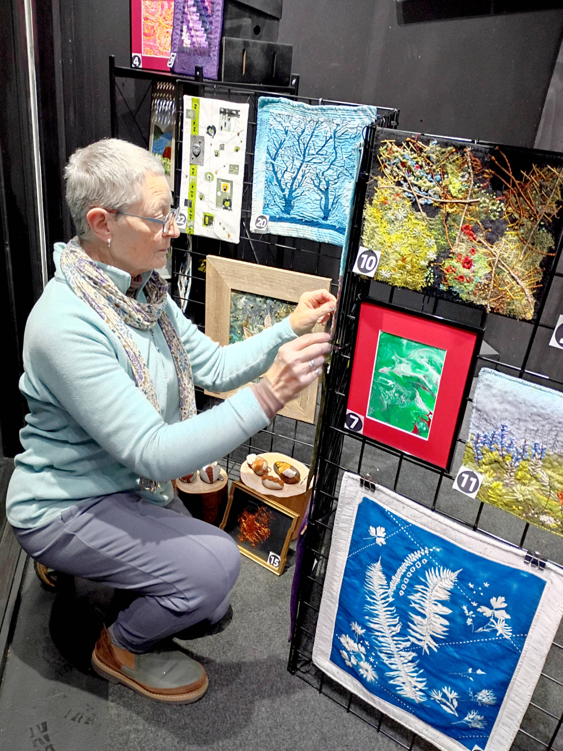 Debra E. Olson, a Port Townsend fiber artist, puts the finishing touches on the “Small But Mighty” exhibit at 675 Tyler St. in uptown Port Townsend.