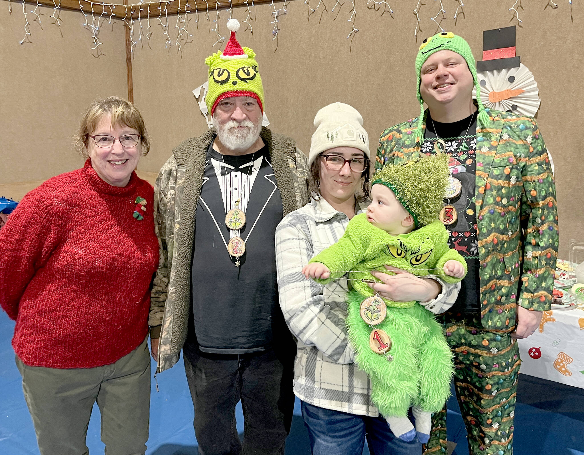 Pictured, from left, are Rae Leiper, president of the Joyce Fire Auxiliary; Keith Sowders, runner-up Grinch; Larrissa Garrison with Jayce, the 2025 Joyce Grinch; and second runner-up Grinch Brian Rice.