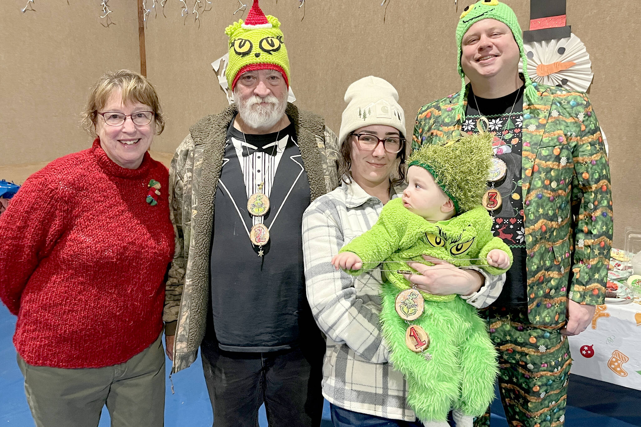 Pictured, from left, are Rae Leiper, president of the Joyce Fire Auxiliary; Keith Sowders, runner-up Grinch; Larrissa Garrison with Jayce, the 2025 Joyce Grinch; and second runner-up Grinch Brian Rice.