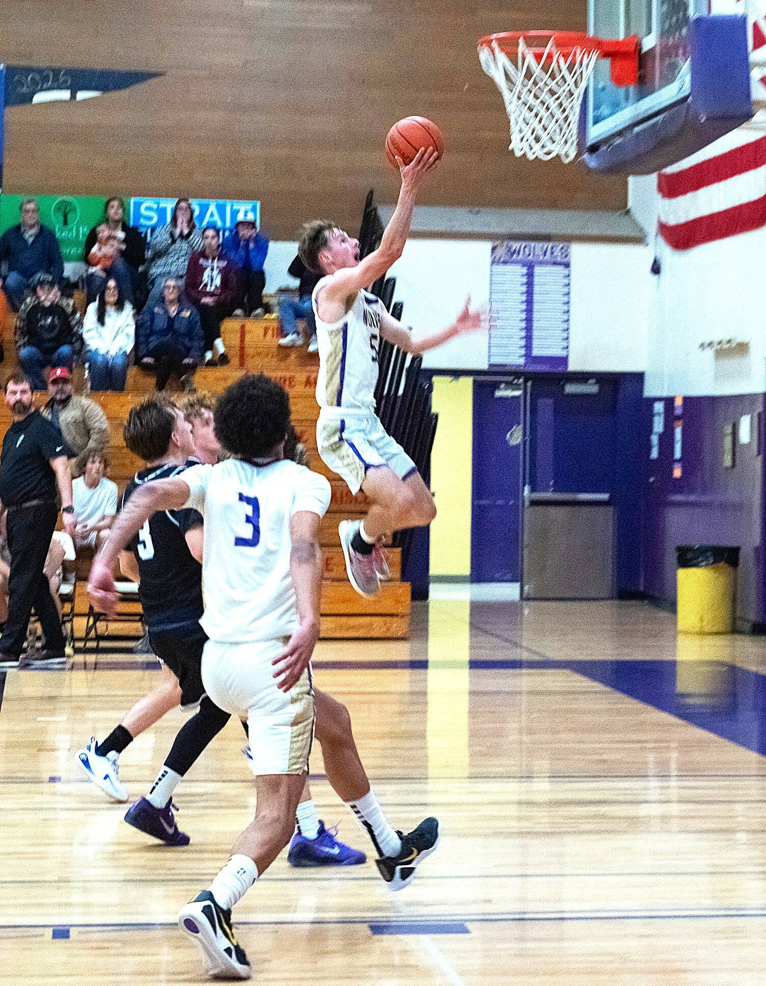 Sequim’s Mason Rapelje goes in for a layup during Friday’s victory over North Mason. The Wolves came back from a double-digit deficit to win 64-56. (Emily Matthiessen/for Peninsula Daily News)