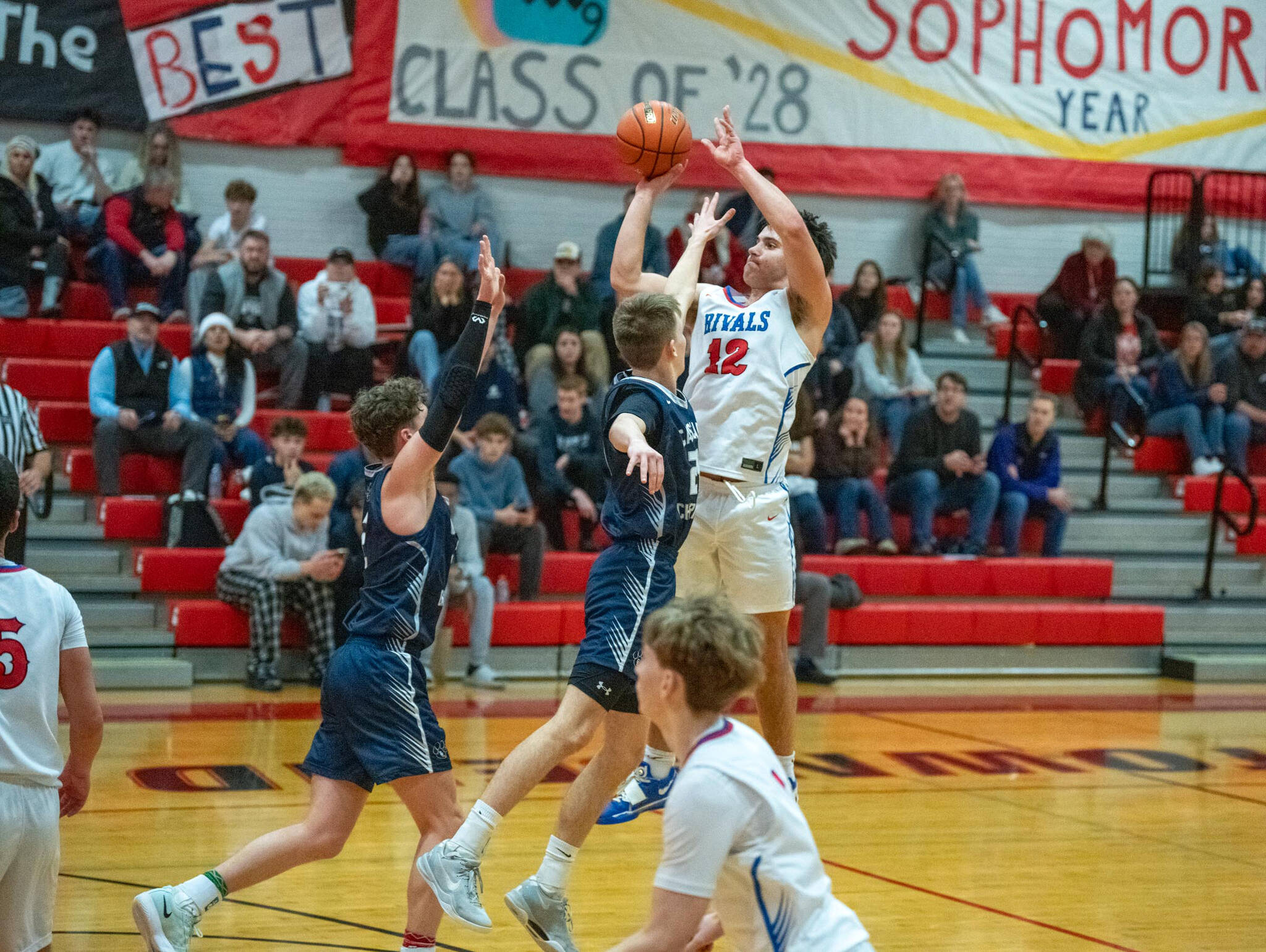 Steve Mullensky/for Peninsula Daily News
East Jefferson’s Luke O’Hara drains a 3-pointer from the top of the key over the outstretched arm of a Cascade Christian opponent during a Nisqually League game at Bruce Blevins Gymnasium.