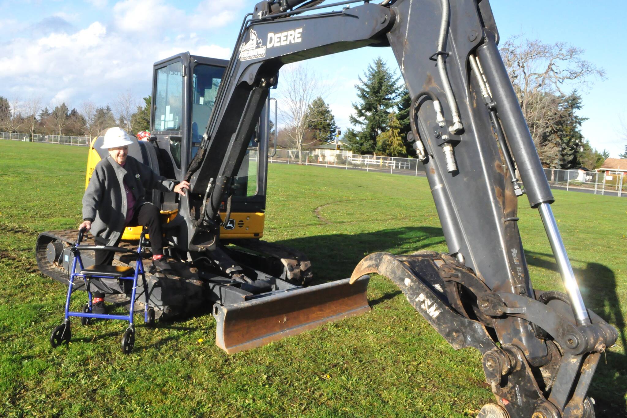Marylaura Ramponi stands by an excavator donated for geotechnical work at Sequim School District by Jamestown Excavating. She donated $1 million for the naming rights of the Ramponi Center for Technical Excellence, a career and technical education building that will be built in conjunction with new buildings at Sequim High School. (Matthew Nash/Olympic Peninsula News Group)
