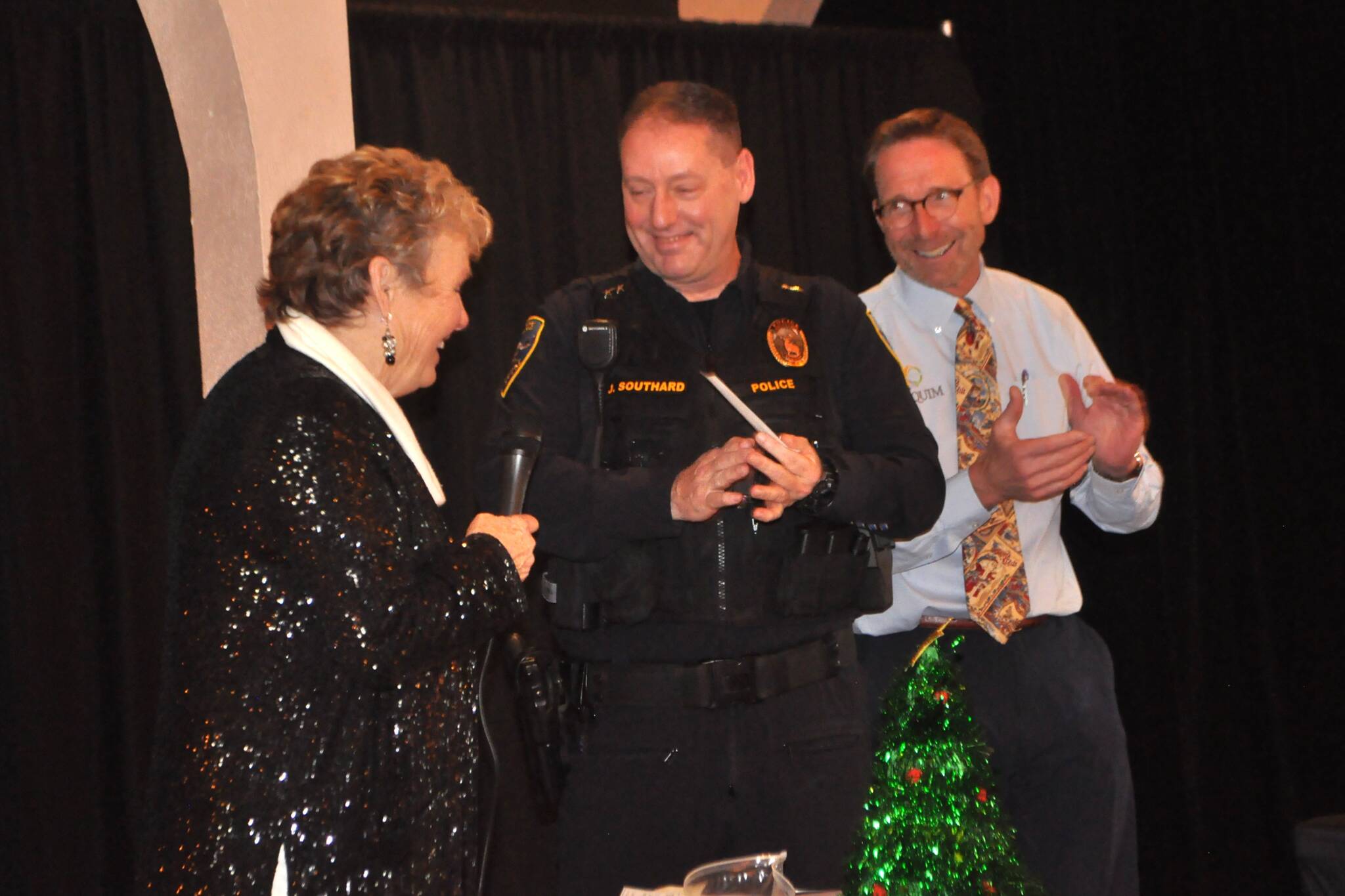 Deb Carlson, president of the Sequim-Dungeness Hospital Guild, presents a check for $9,585 to Deputy Police Chief John Southard and City Manager Matt Huish to help purchase three automated external defibrillators (AEDs) for three new vehicles and new AED pads and first aid supplies for the full fleet. (Matthew Nash/Olympic Peninsula News Group)