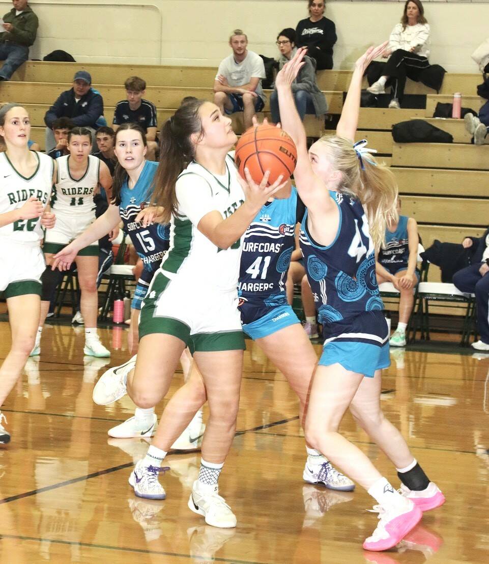 Port Angeles’ Sariah Doherty drives the lane against the Surfcoast Chargers, a team from Melbourne, Australia. (Dave Logan/for Peninsula Daily News)