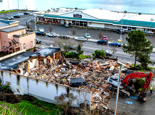 The Sanderling Building, a vacant office building on Water Street across from Quimper Mercantile in downtown Port Townsend, underwent exterior demolition on Monday to clear the lot for a 50-room hotel to be built by BJC Group of Port Orchard. Interior demolition started last week and the site should to be cleared in about a week and a half. (Steve Mullensky/for Peninsula Daily News)